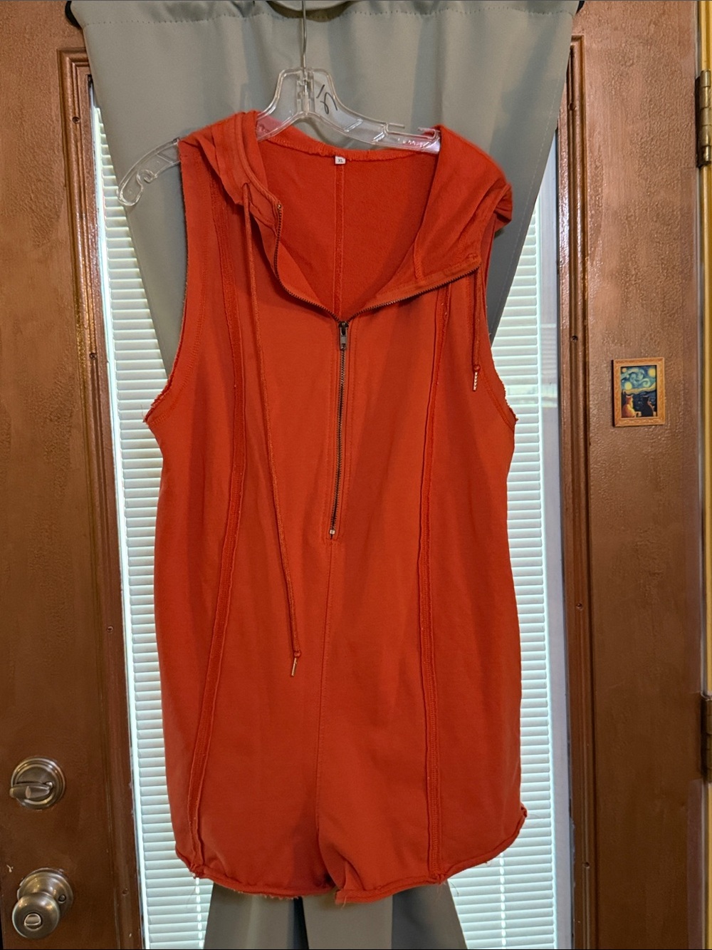 Romper size xl. Orange with hood and metal zipper.